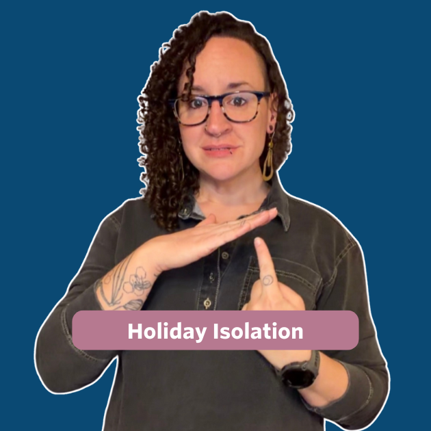 The post features a video thumbnail with a blue overlay. Centered on the image is a rose-colored text bubble with white lettering that reads “Holiday Isolation.” In the video, Bee, a white queer person with long, curly hair, is wearing a dark gray denim top and blue–light brown framed glasses.
