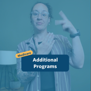 The post has a video thumbnail with blue shading overlaid. The top middle has "Medicare: Additional Programs” in white text with light blue background, accompanied by a yellow bubble with “Medicare” in blue. In the video: A nonbinary person with long, curly brown hair that is shaved on the right side of their head and pulled back stands in front of the camera. Behind them is a small light wooden table with a potted plant set against a green wall. They are wearing a light plum short sleeved button down shirt over a black top and black pants.